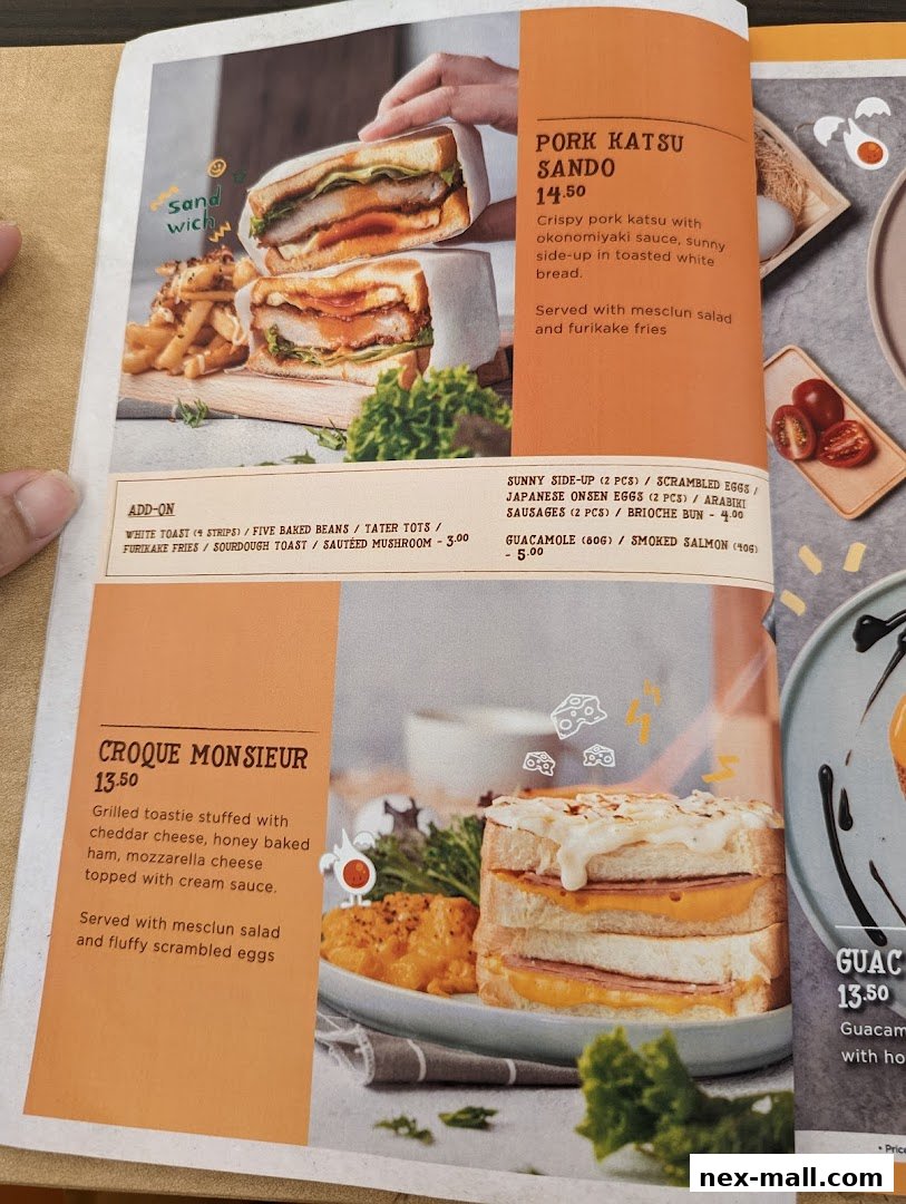 A menu featuring Pork Katsu Sando and Croque Monsieur sandwiches with side dishes.