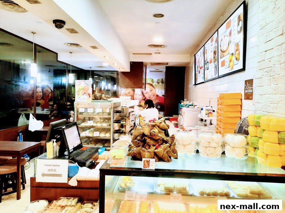 Interior view of Ho Kee Pau, showcasing display cases filled with pastries and a counter with a computer.