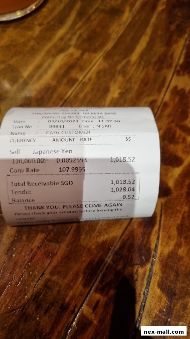 A receipt from AL Thasneem Traders Money Changer showing a currency exchange transaction.