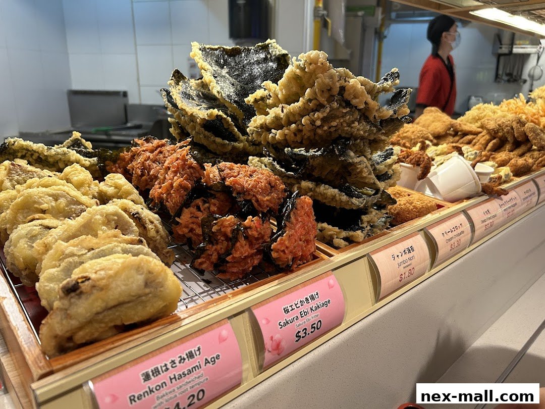 A display of various fried Japanese tempura items, including lotus root and shrimp fritters.