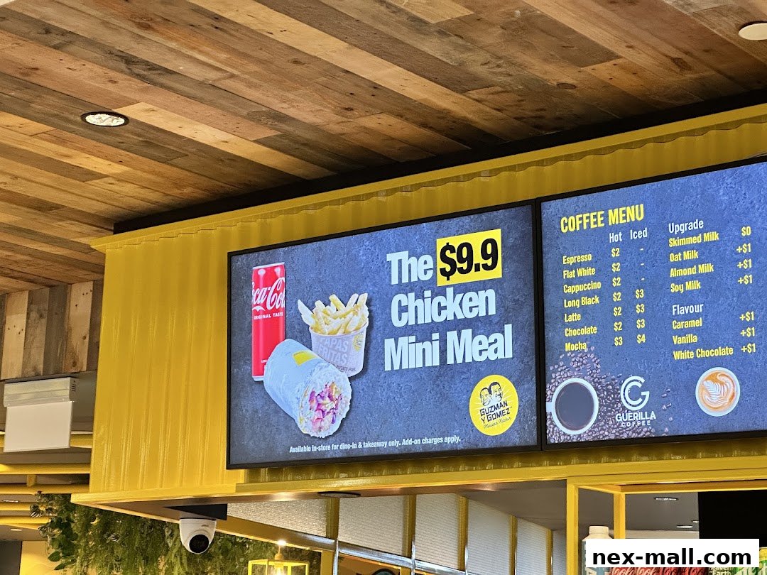 Digital menu boards display a $9.9 Chicken Mini Meal and a coffee menu.