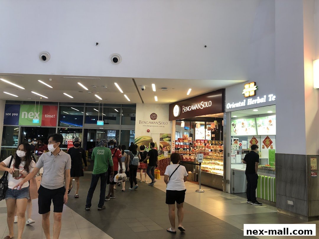 People walking past shops, including Bengawan Solo and Oriental Herbal Te.