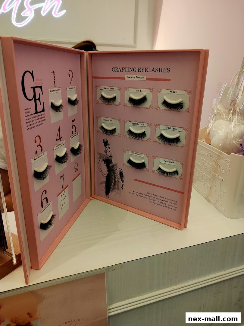 A display book showcasing different styles of eyelash extensions with sample lashes.