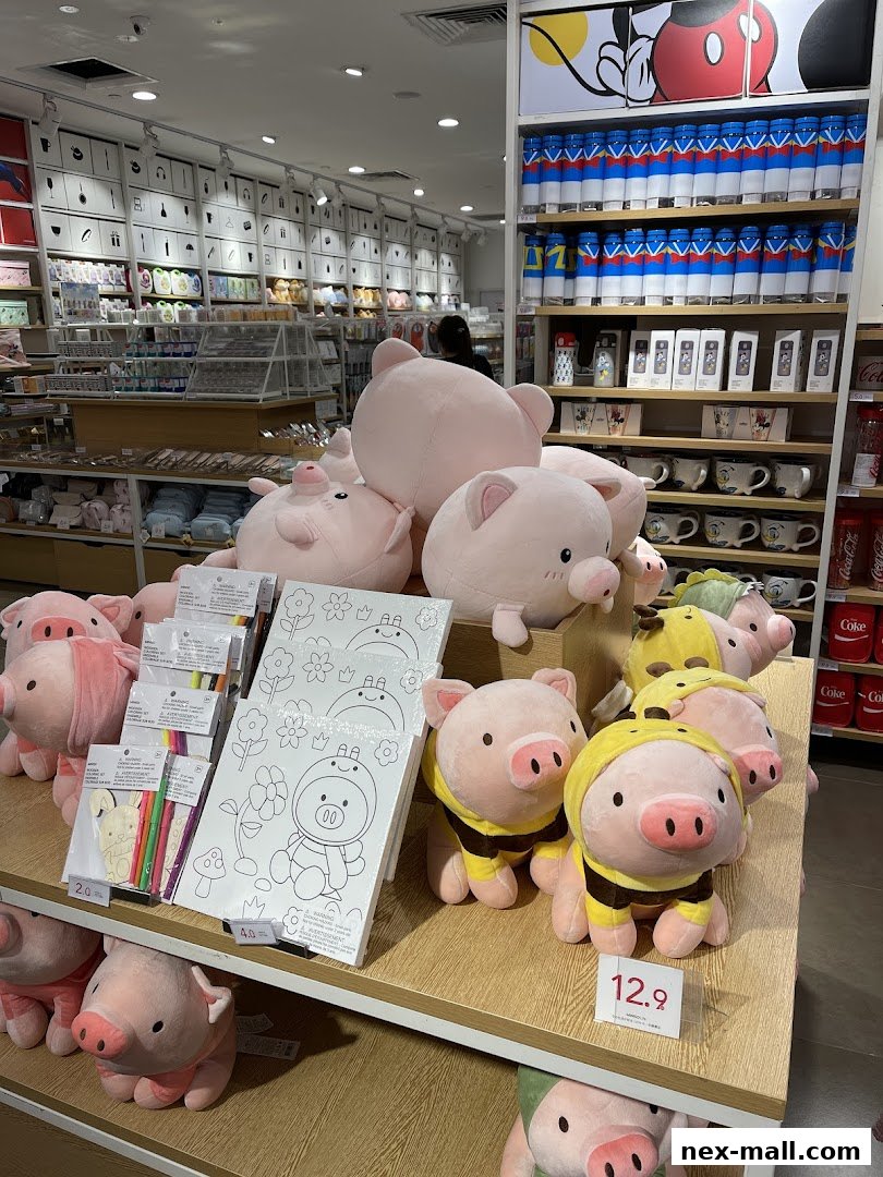 A display of cute pig plush toys and art supplies in a retail store.