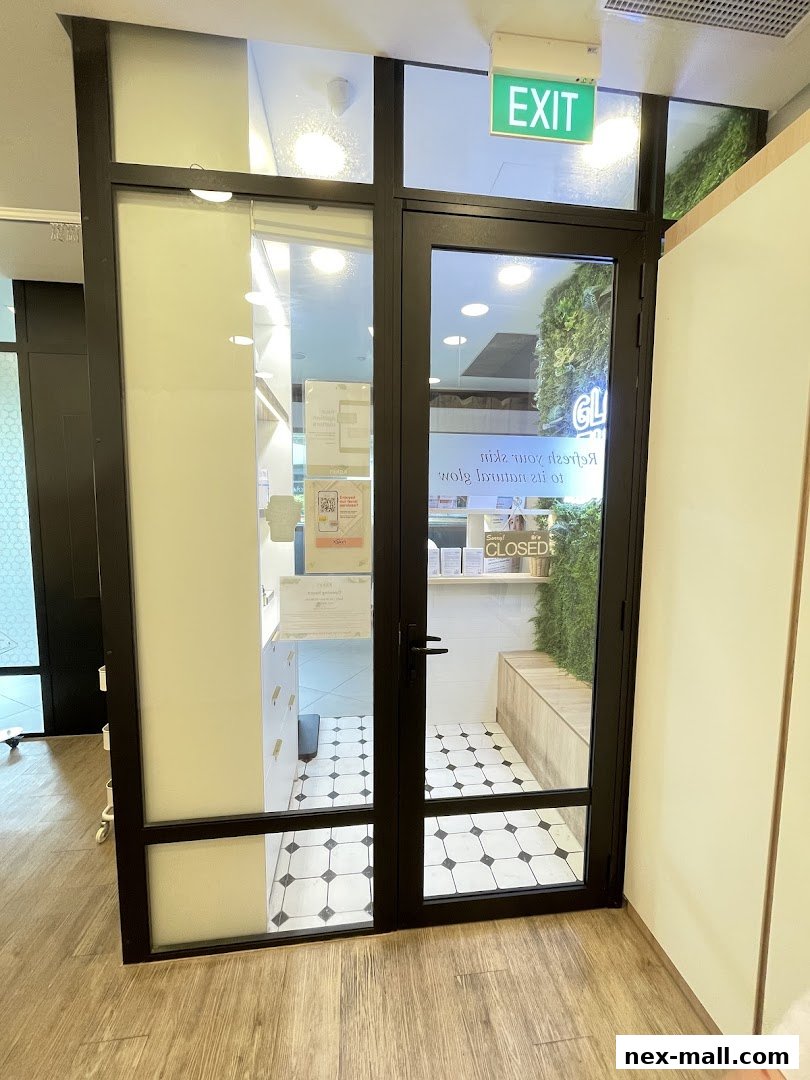 The entrance to Kskin Korean Express Facial, featuring glass doors and an 'EXIT' sign.