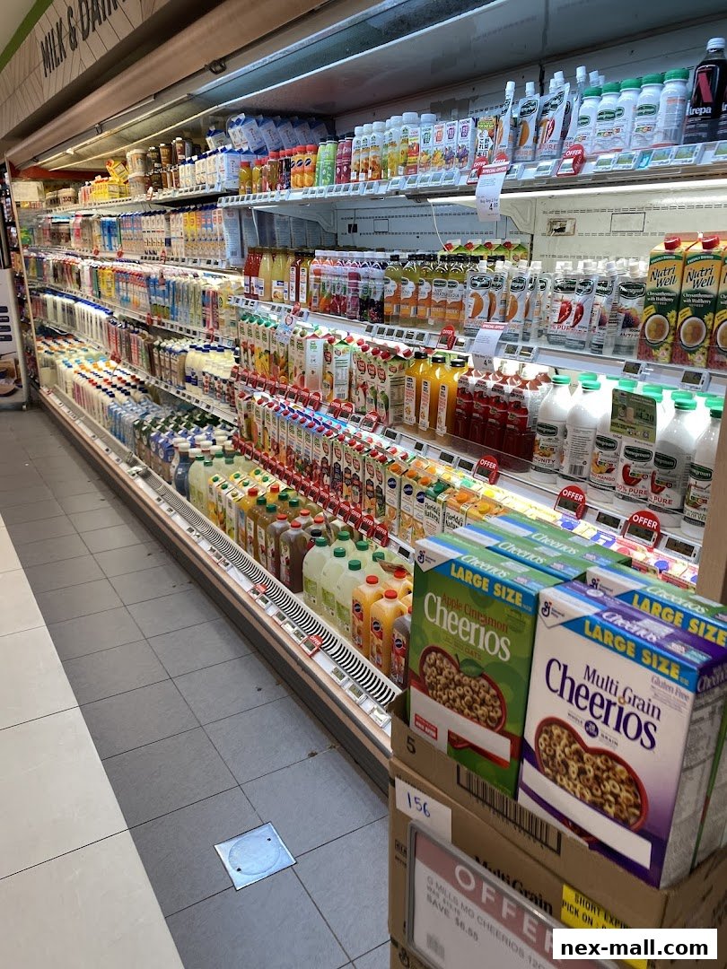 A refrigerated aisle in a supermarket stocked with various beverages and cereals.