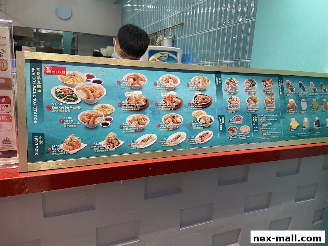 A menu board for Koo Kee Yong Tow Foo Mee, showcasing various dishes and drinks.