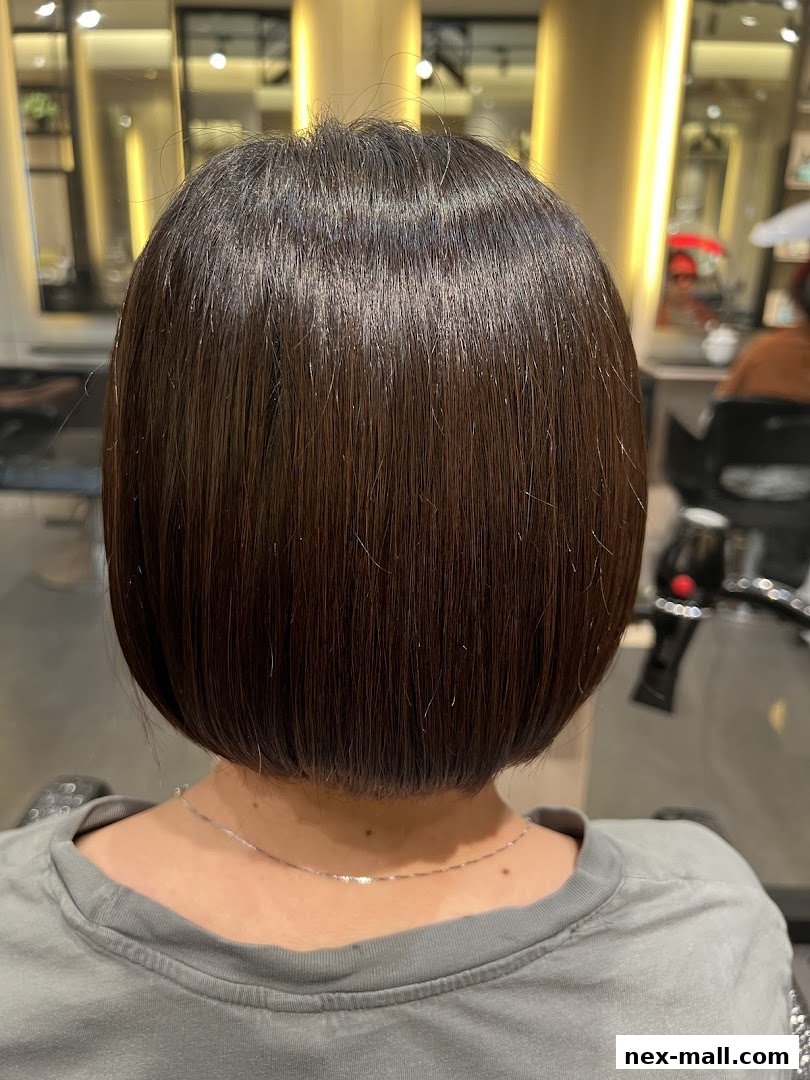 Back view of a person with a sleek, dark brown bob haircut.