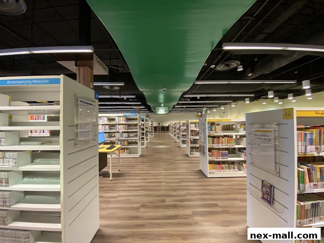 Interior view of a modern library with rows of bookshelves and reading areas.
