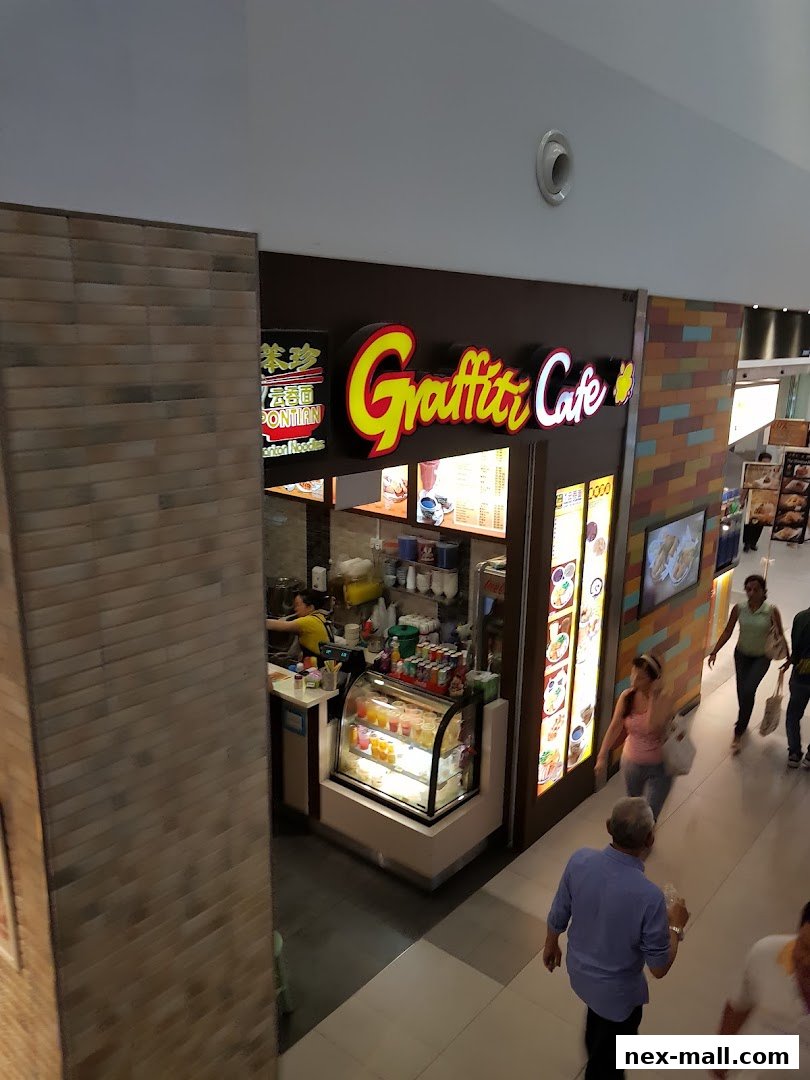 The exterior of Graffiti Cafe, a brightly lit eatery with a prominent sign and display cases.