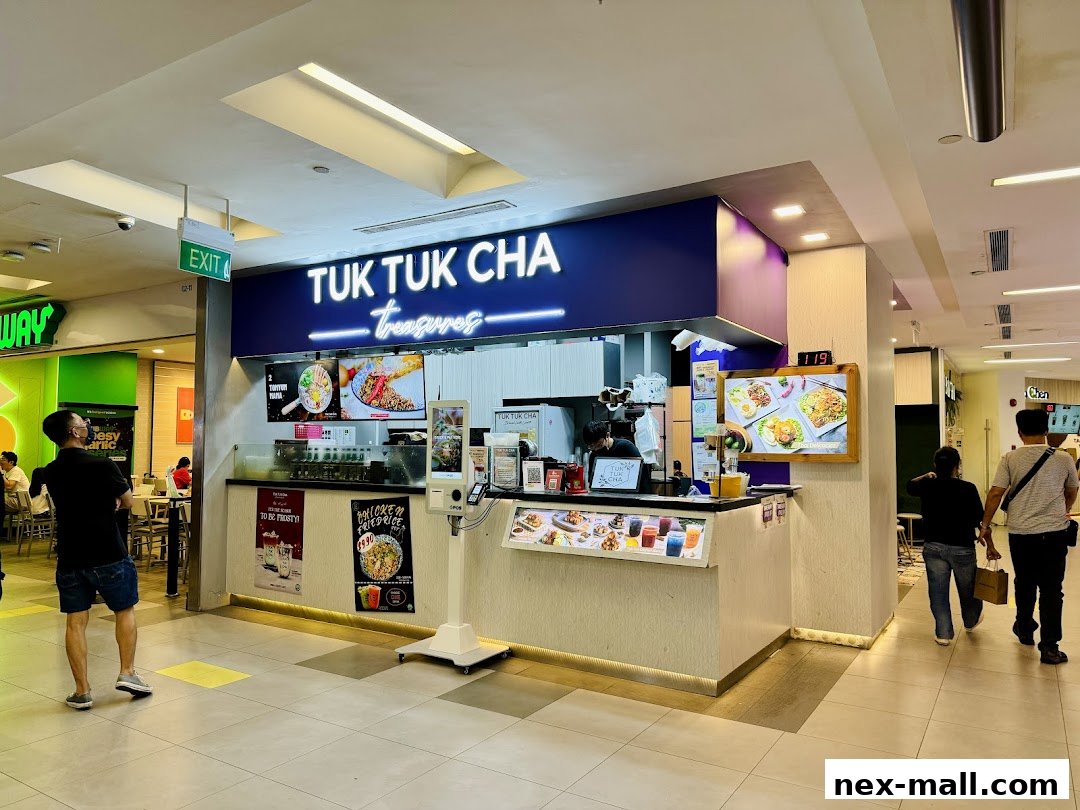 The Tuk Tuk Cha Treasures shop front with food displays and customers.