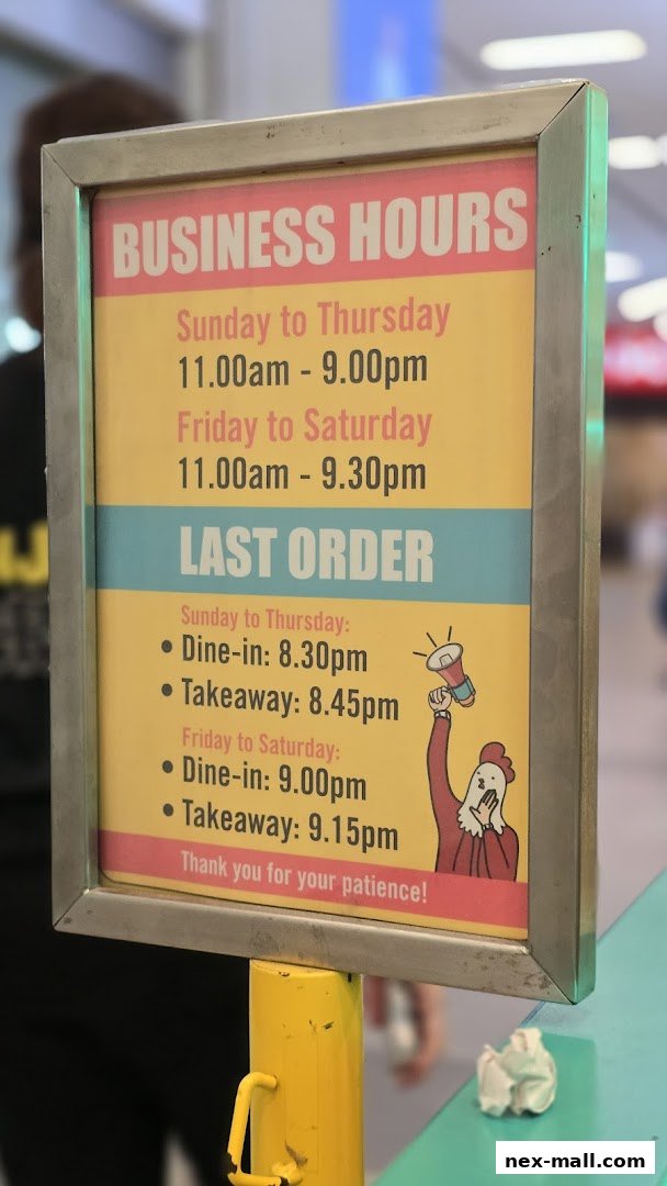 A sign displaying business and last order hours for JINJJA Chicken.