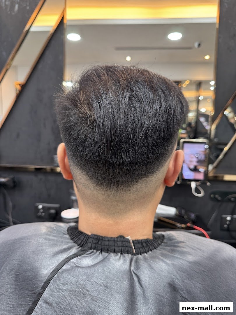 A person's head from behind, showcasing a fresh haircut with a fade.