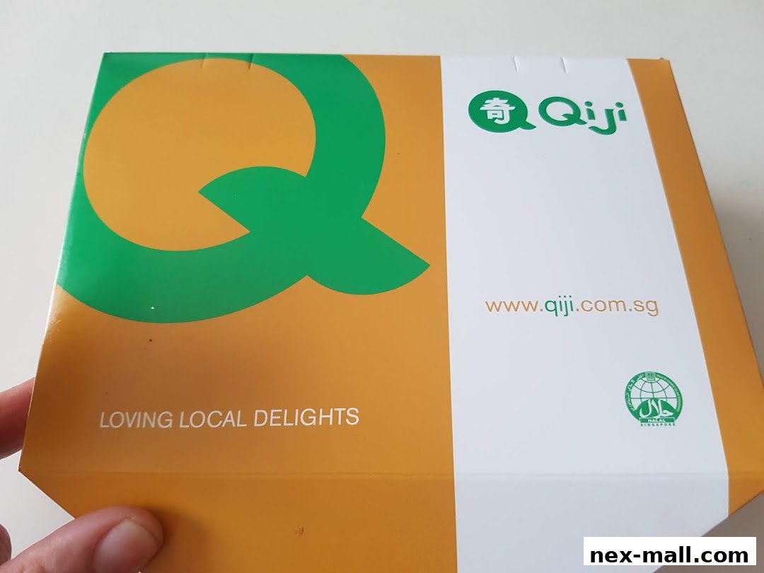 A Qi Ji branded box with a large green Q logo and website address.