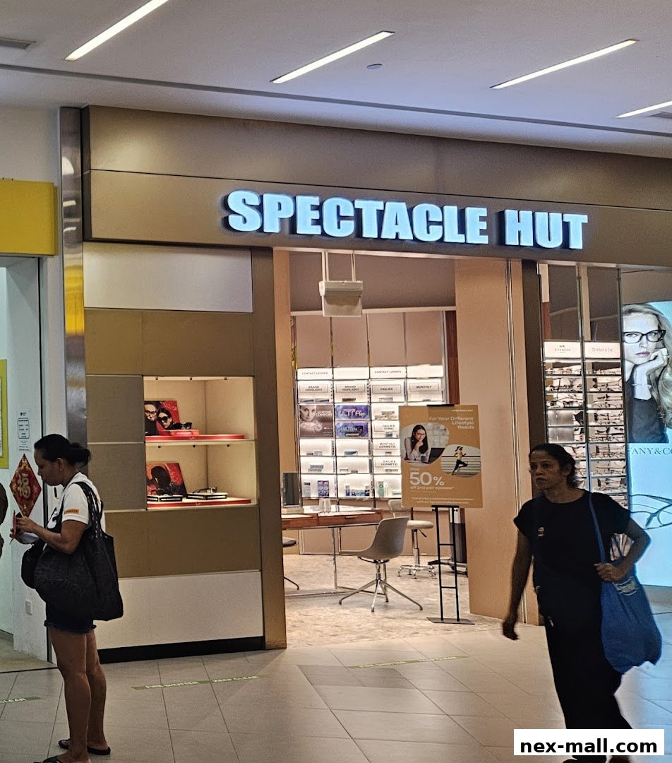 The entrance of Spectacle Hut, an optical shop, displaying eyewear and contact lenses.