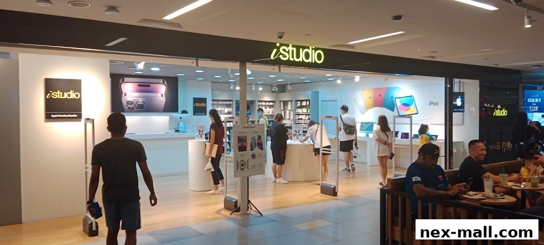 The iStudio NEX store entrance with customers browsing Apple products and displays.