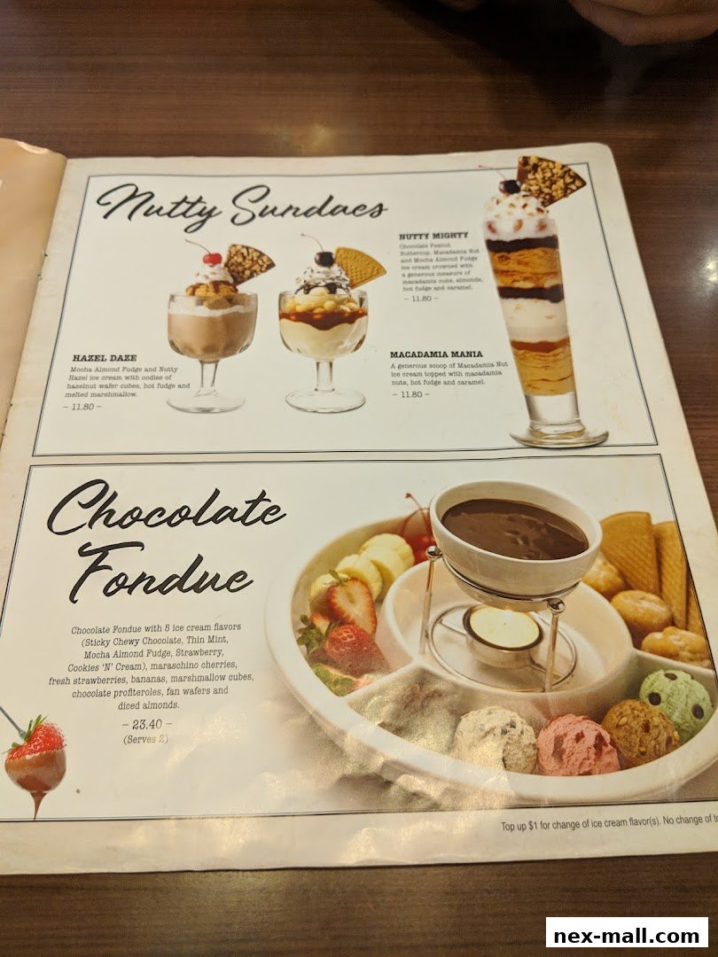 A menu page showcasing decadent sundaes and a chocolate fondue with ice cream.