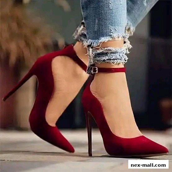A close-up shot of a person wearing stylish red high-heeled shoes with ankle straps.