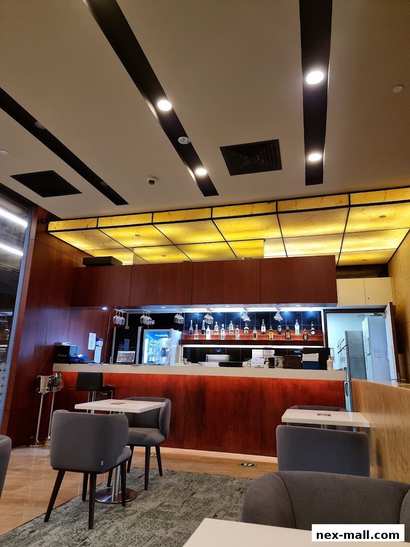 Interior shot of a modern bar area with seating and a well-stocked bar.