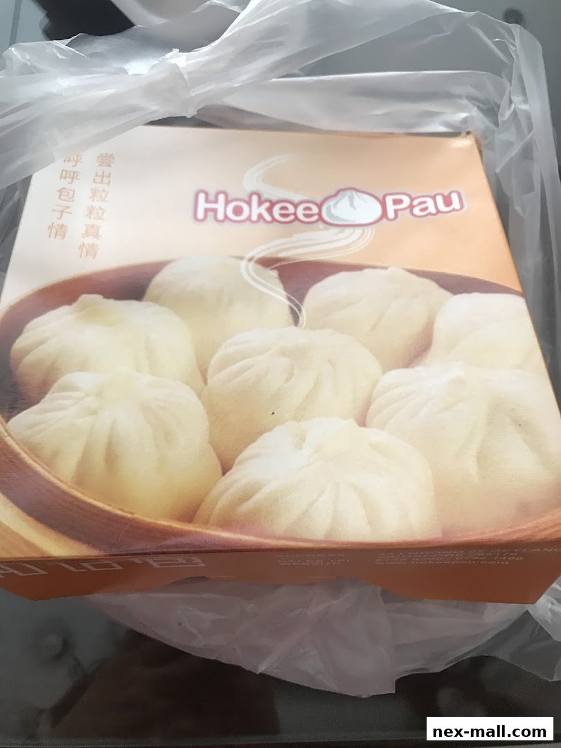 A box of steamed buns from Ho Kee Pau, featuring an image of several plump buns.
