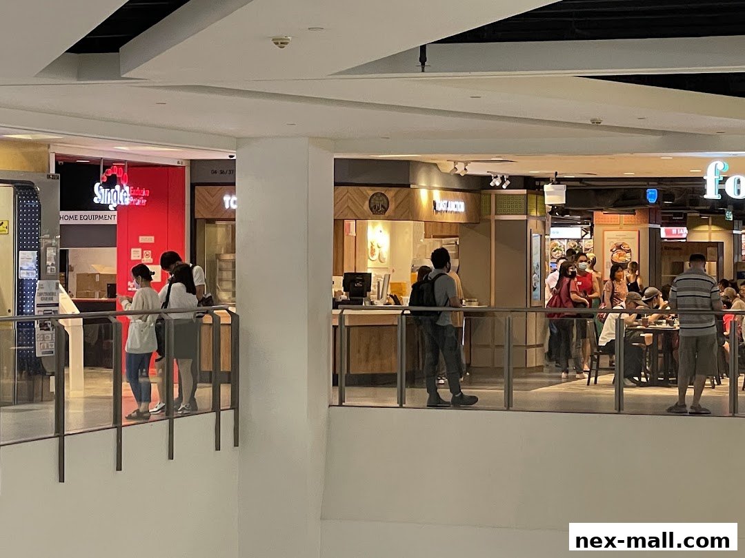 People browsing shops and a food court area in a mall.