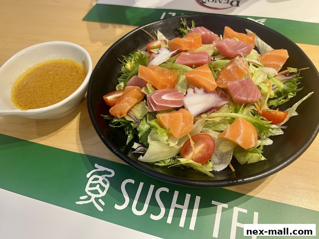 A fresh sashimi salad with salmon, tuna, and octopus, served with dressing.