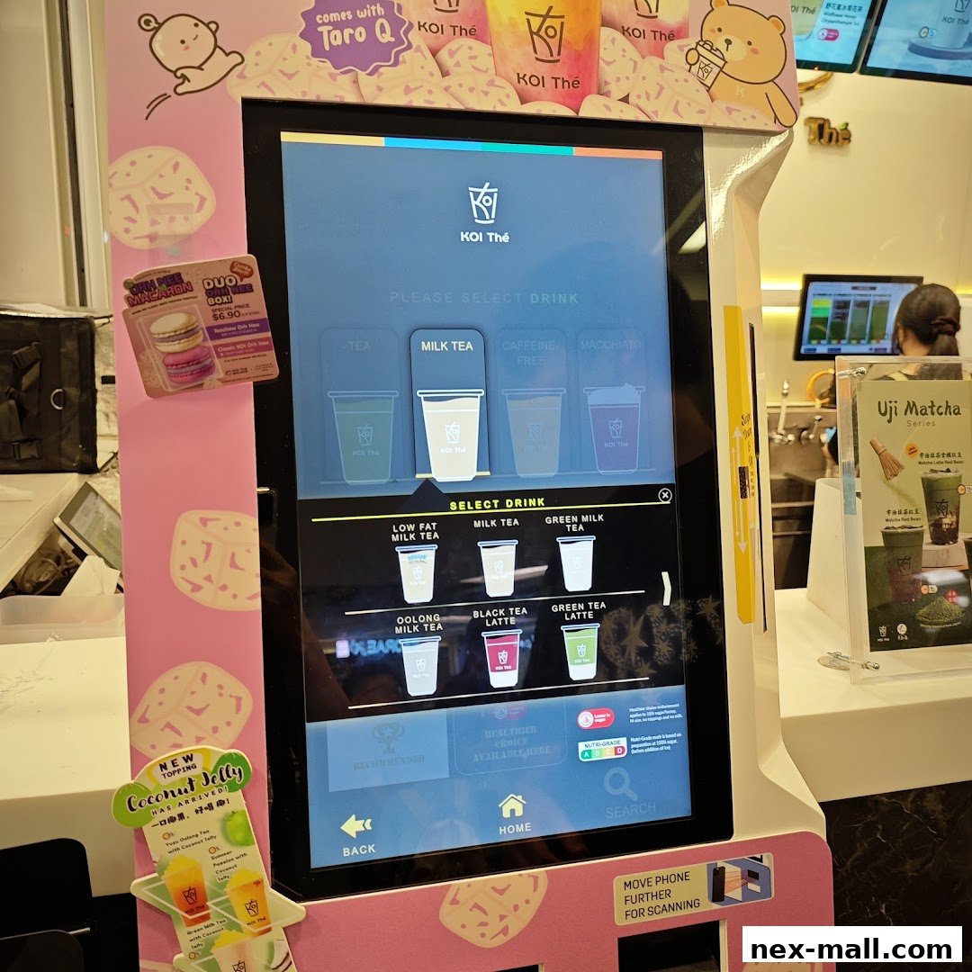 A self-ordering kiosk for KOI Thé, displaying drink options and promotions.