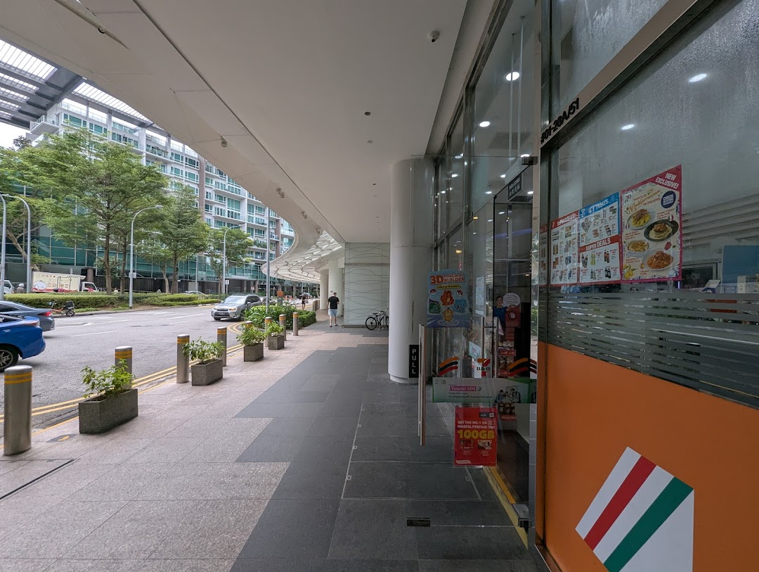The exterior of 7-Eleven Plaza Singapura, featuring its entrance, a wide sidewalk, and a street view.