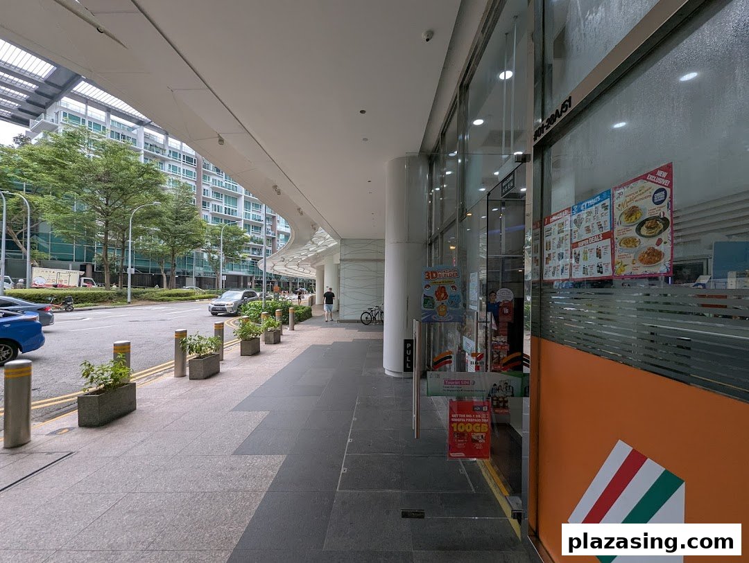 The exterior of 7-Eleven Plaza Singapura, featuring its entrance, a wide sidewalk, and a street view.