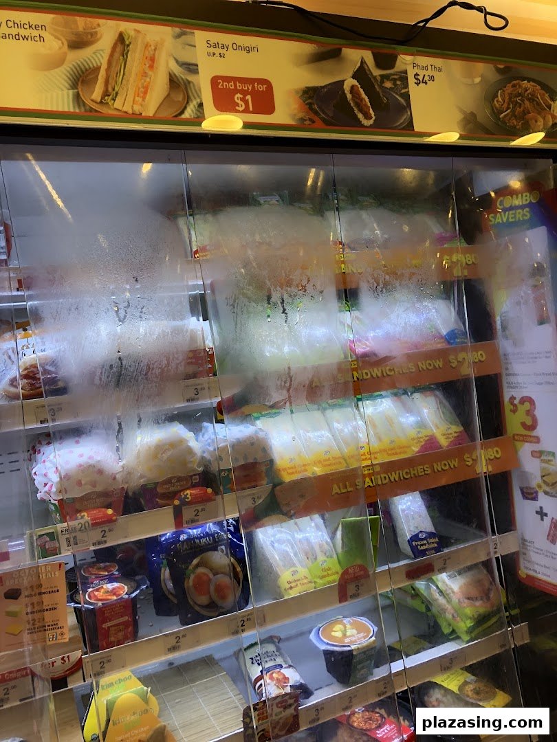 A refrigerated display case at 7-Eleven showcasing a variety of ready-to-eat meals, sandwiches, and snacks.