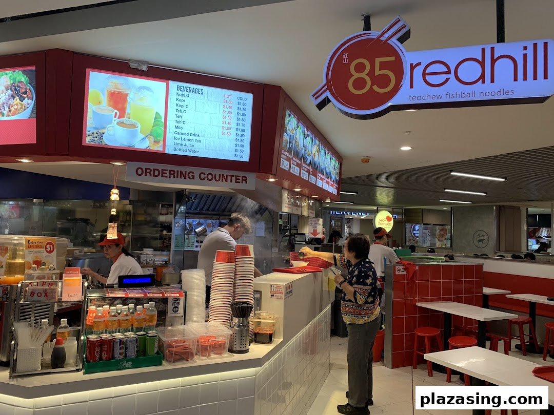 A vibrant interior shot of 85 Redhill Teochew Fishball Noodle, featuring the ordering counter and beverage menu.