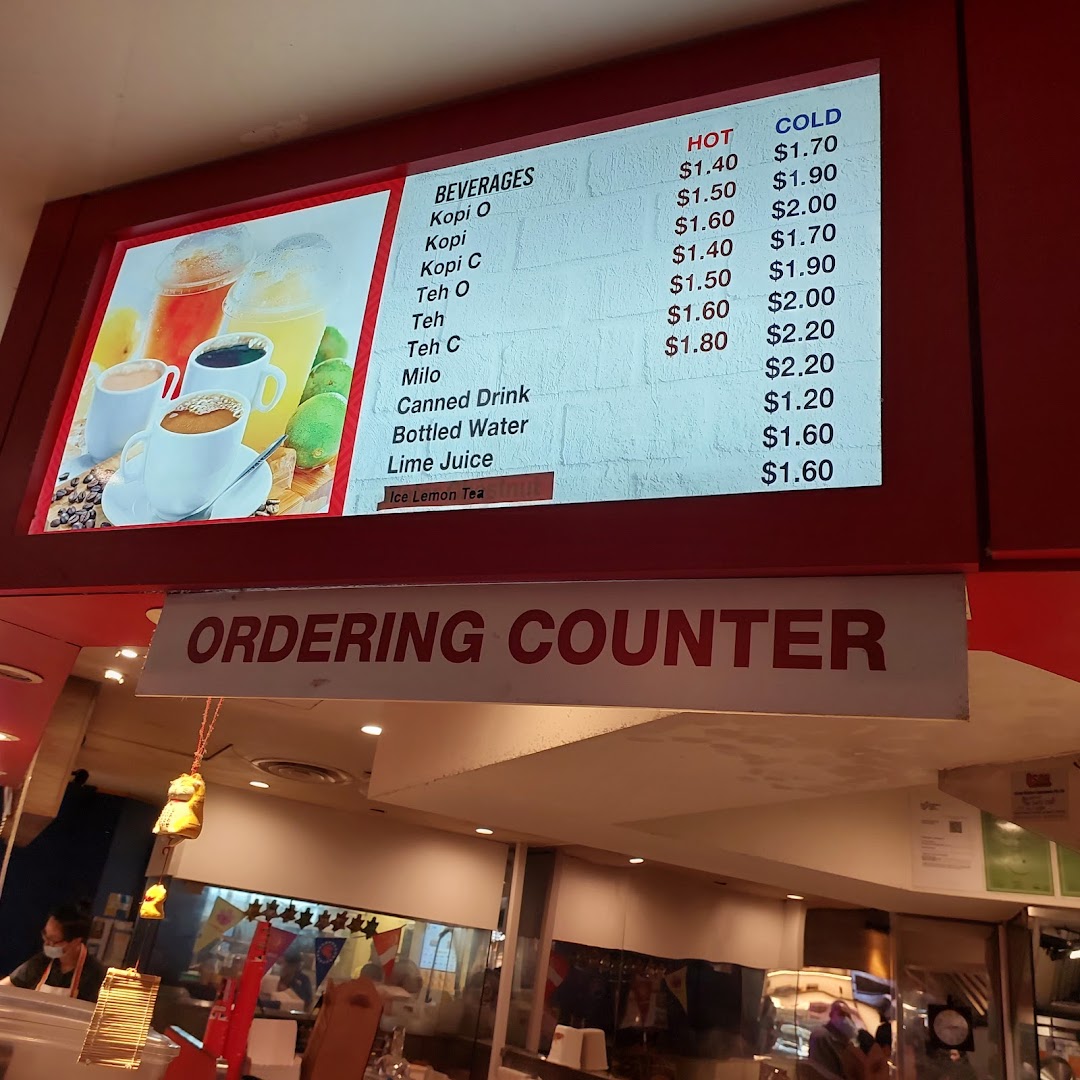 A digital menu board displaying hot and cold beverage options with prices at an ordering counter.
