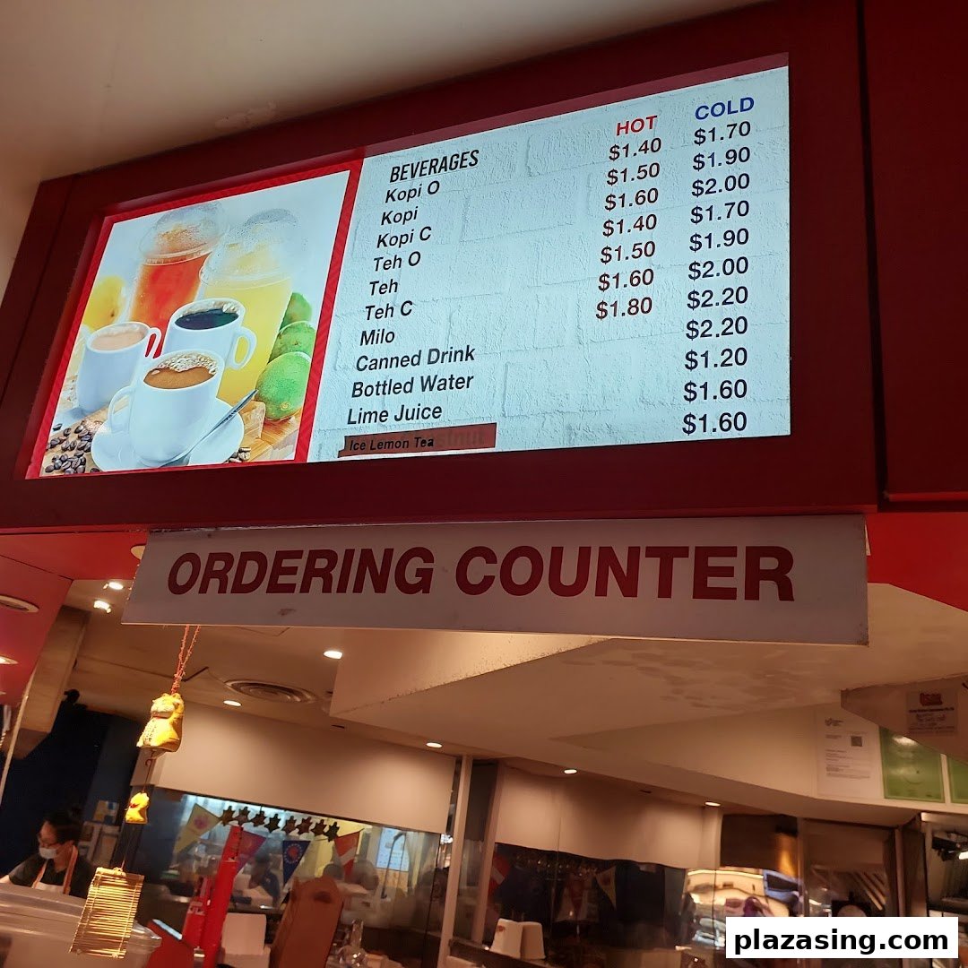 A digital menu board displaying hot and cold beverage options with prices at an ordering counter.