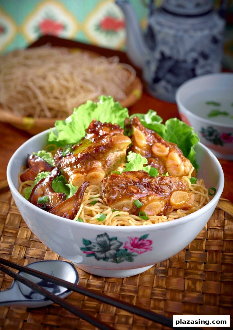 A close-up of a delicious bowl of noodles topped with braised pork ribs and fresh lettuce.