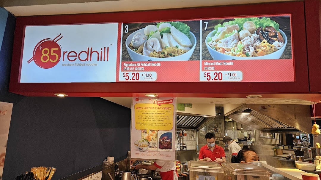 A digital menu board displaying Signature Fishball Noodle and Minced Meat Noodle with prices at 85 Redhill.
