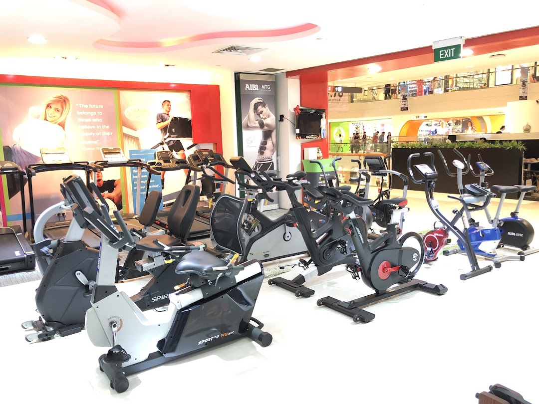 A wide view of Aibi store interior showcasing various fitness equipment like treadmills and exercise bikes.