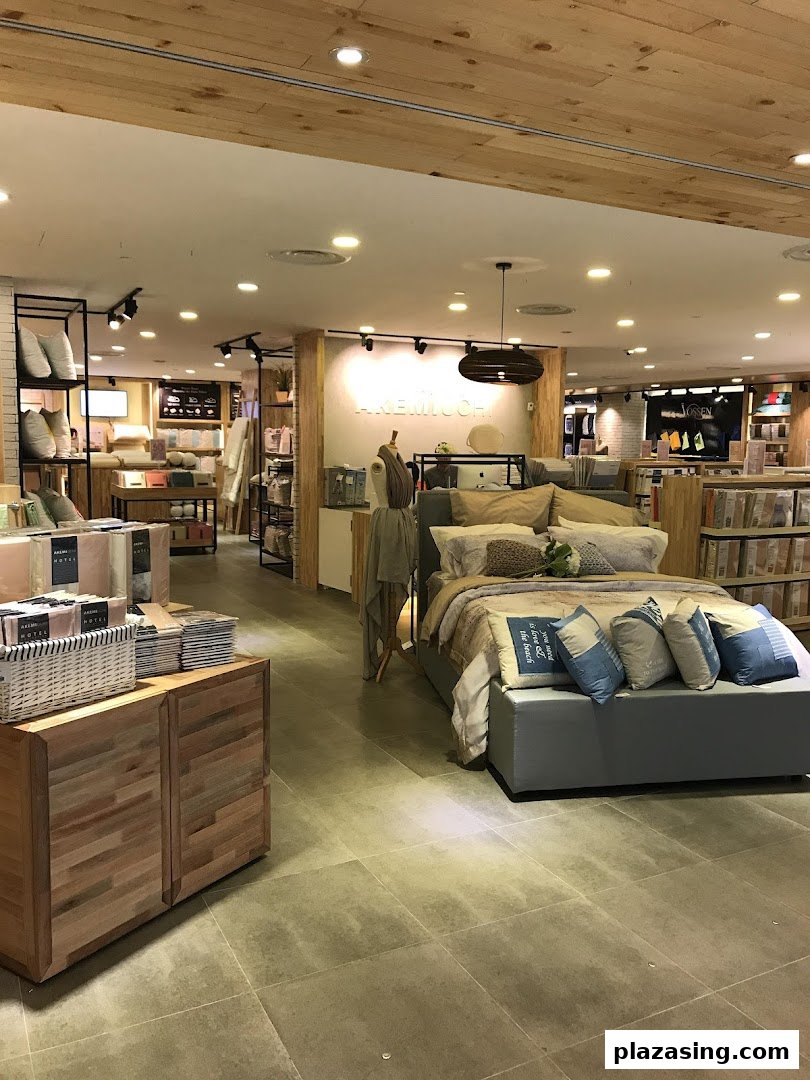 Interior view of AKEMI home textile store, showcasing bedding and home decor displays.