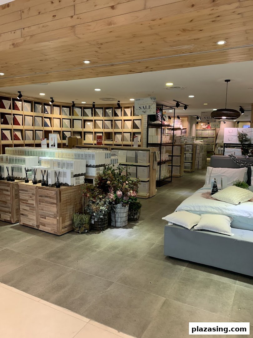 Interior view of AKEMI, showcasing bedding displays, diffusers, and home decor items in a retail setting.