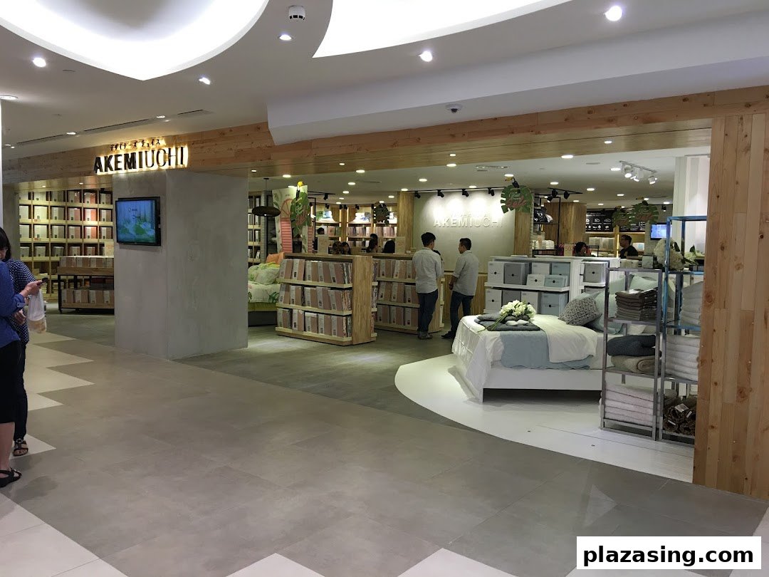 Entrance of AKEMIUCHI home furnishings store, showcasing bedding and home decor displays.