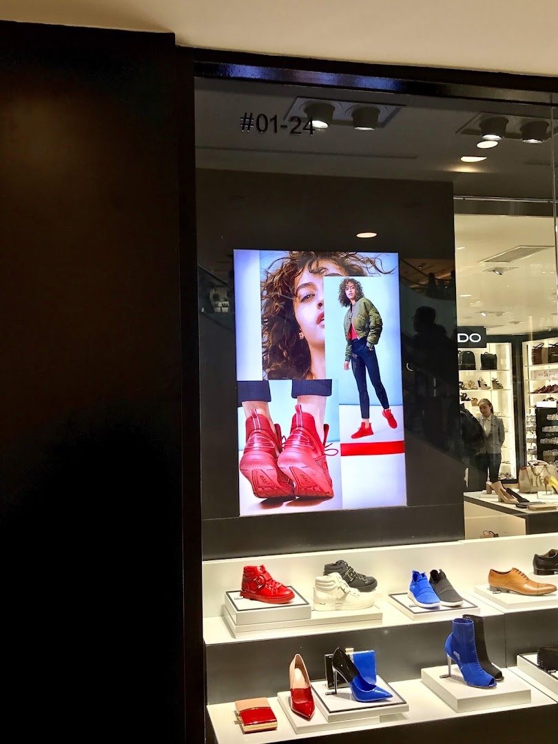 ALDO Plaza Singapura's shop front display features stylish footwear and accessories, with a large digital screen.