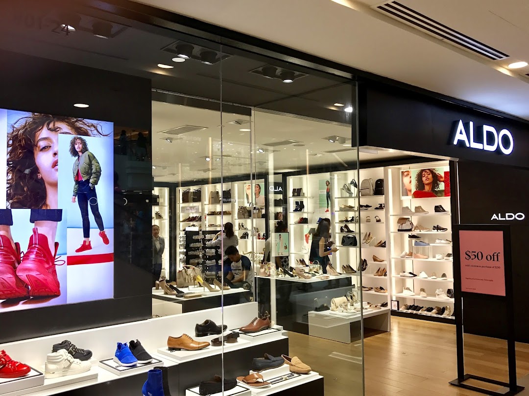 The ALDO shop front showcases a wide array of stylish shoes and accessories through its glass display.