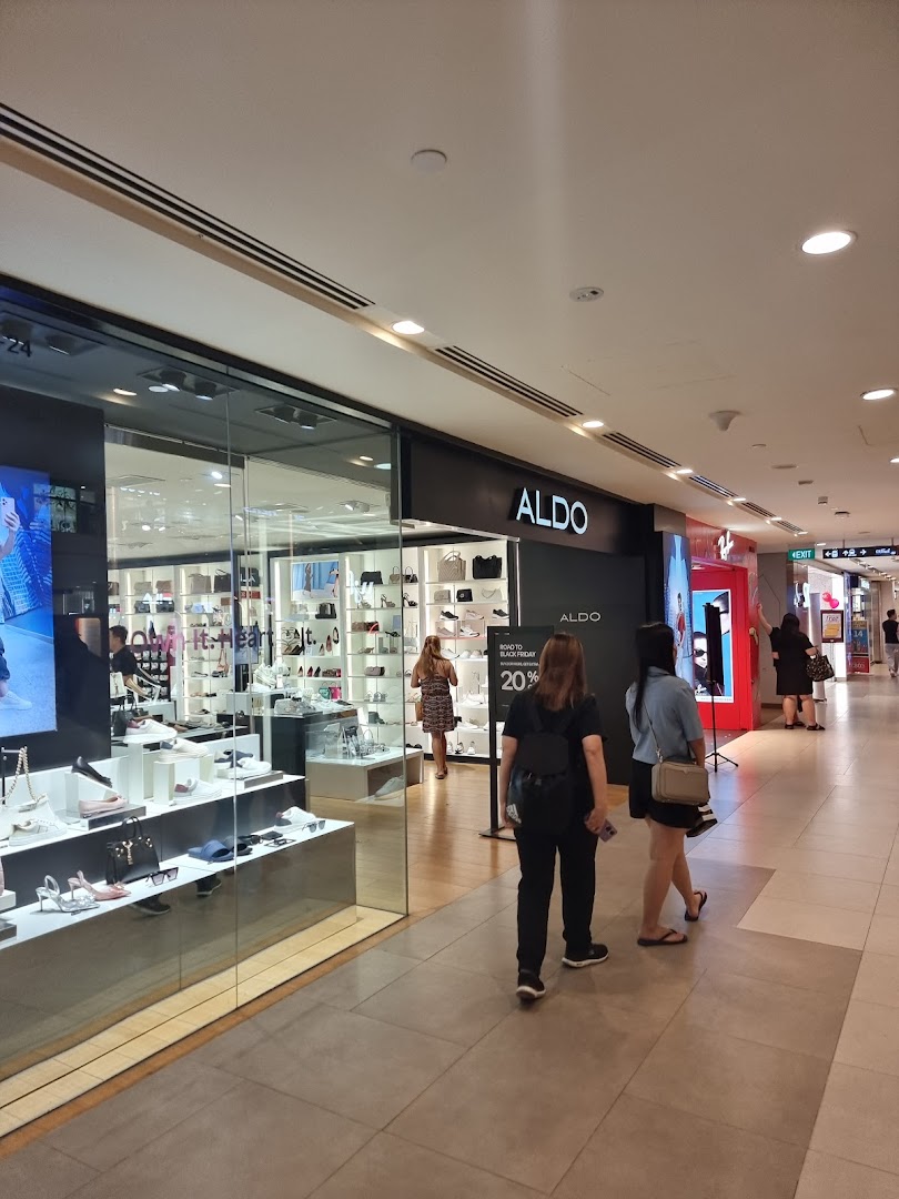 The ALDO shop front in a mall, showcasing shoes and accessories, with shoppers passing by.