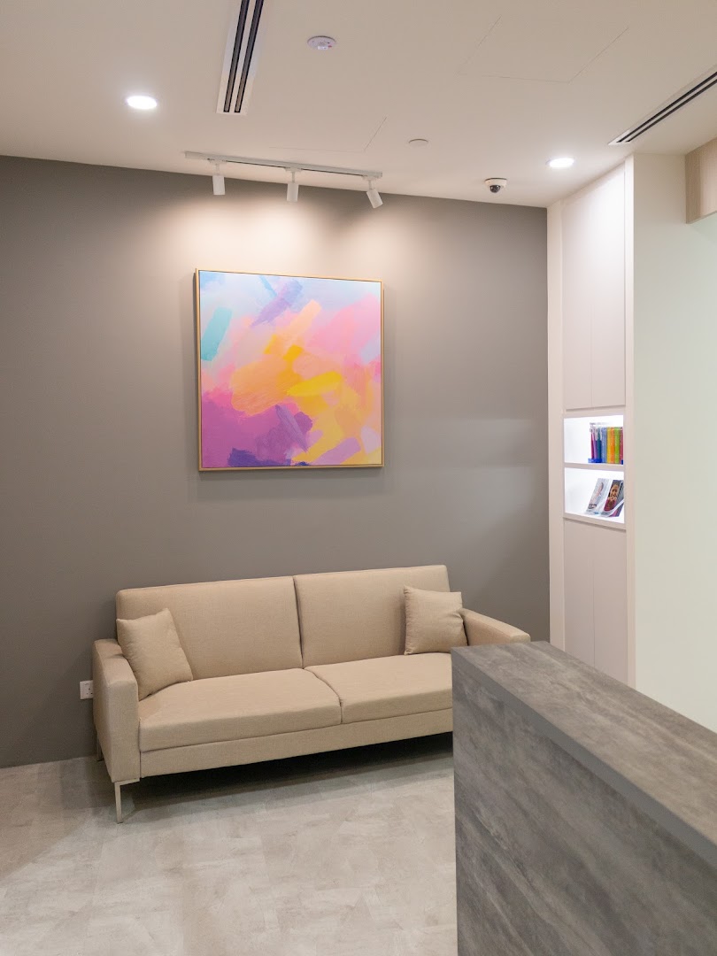 A modern and inviting waiting area inside Align Braces Clinic, featuring a comfortable sofa and vibrant artwork.