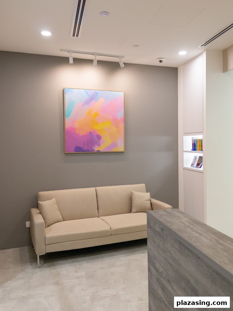 A modern and inviting waiting area inside Align Braces Clinic, featuring a comfortable sofa and vibrant artwork.