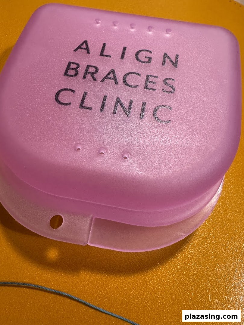A pink case with 'ALIGN BRACES CLINIC' text, likely for dental retainers or aligners.