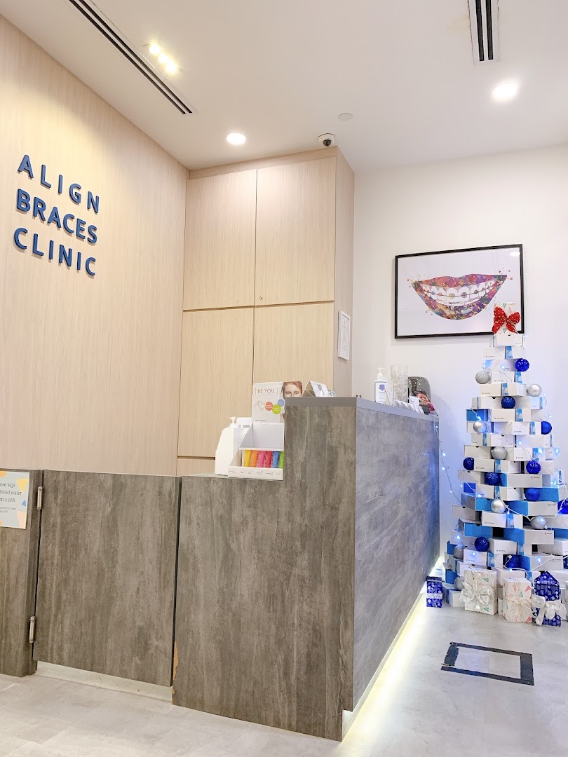 The reception area of Align Braces Clinic, featuring a modern desk, clinic signage, and a festive Christmas tree.