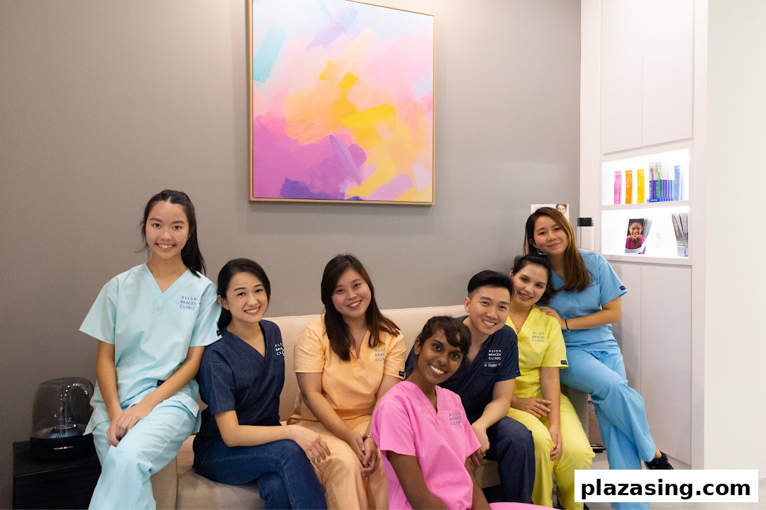 A friendly team of staff from Align Braces Clinic smiling on a couch.