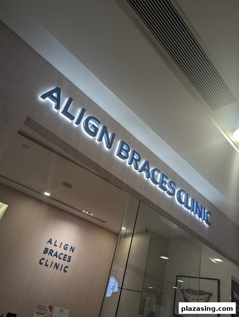 The illuminated exterior signage of Align Braces Clinic at Plaza Singapura.