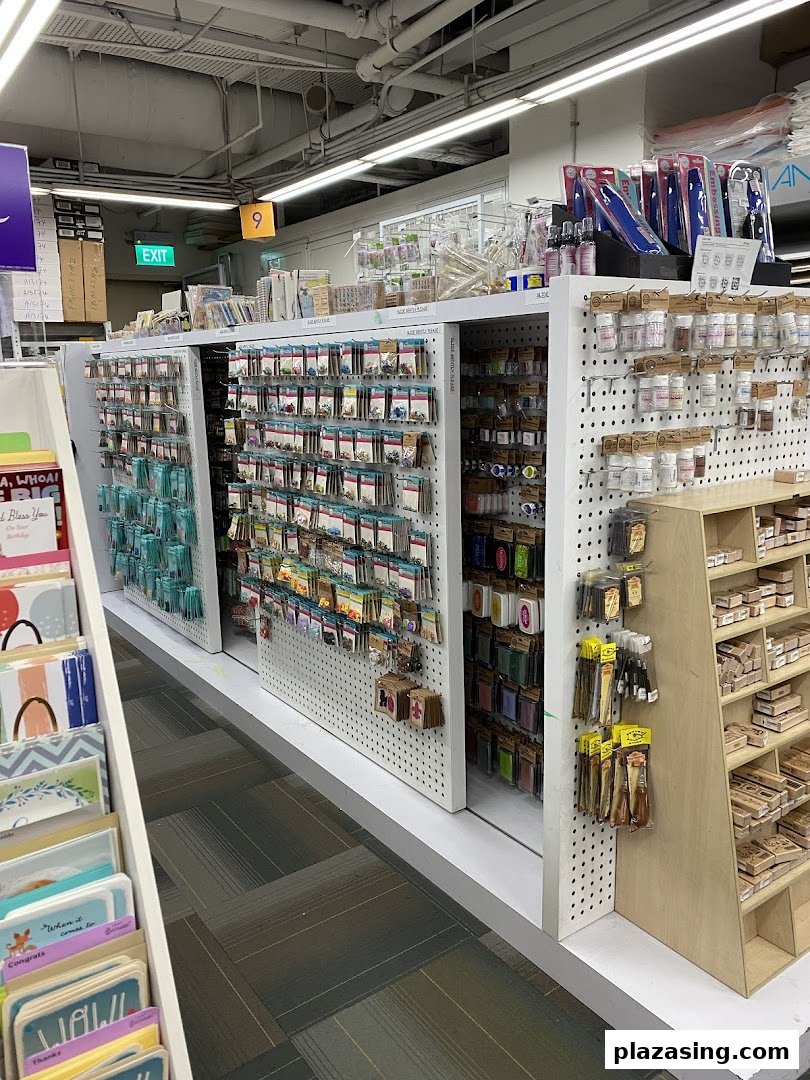 An interior view of Art Friend, showcasing aisles filled with diverse art and craft supplies, including stamps and embellishments.