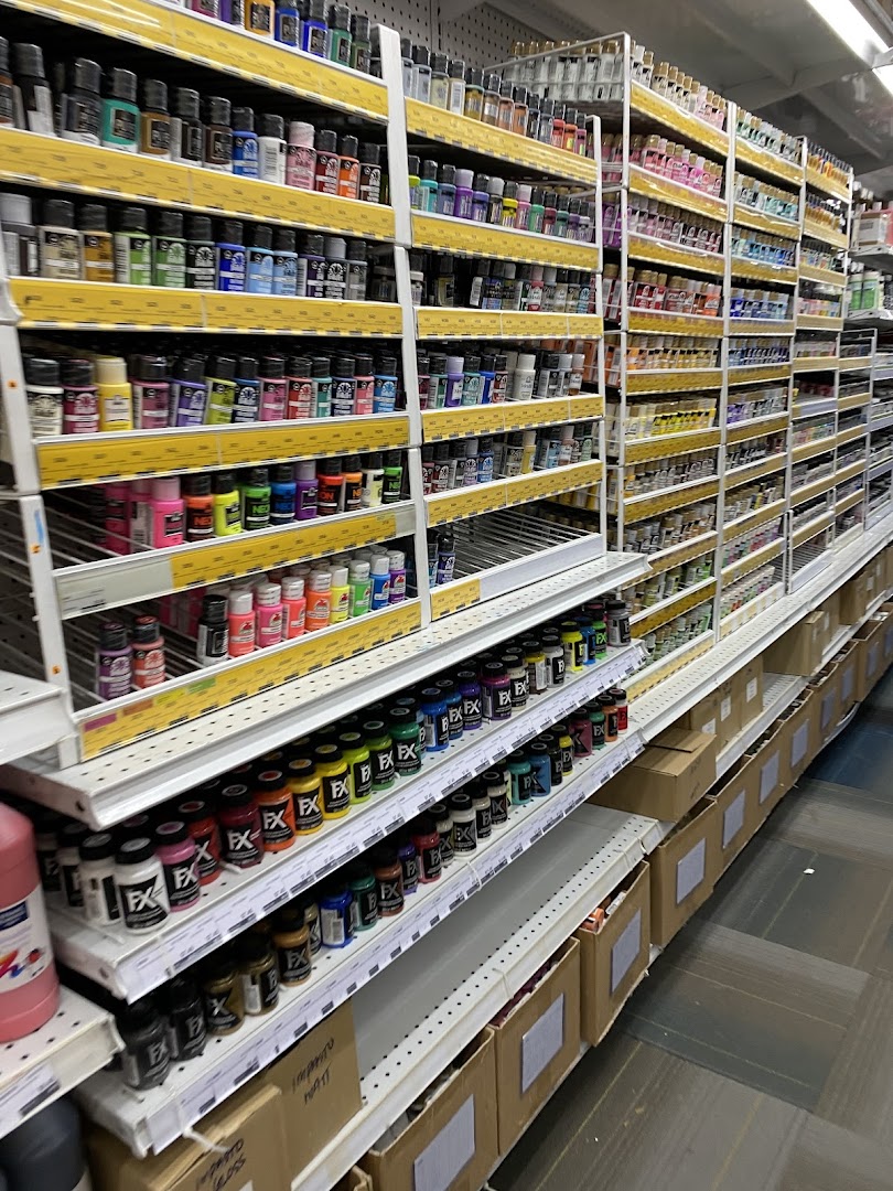 Shelves filled with a wide variety of colorful paints and art supplies at Art Friend.